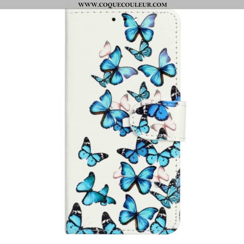 Housse Moto G73 5G Papillons Bleus en Vol à Lanière