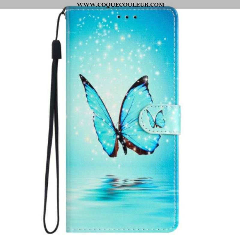 Housse iPhone 15 Papillon Bleu en Vol à Lanière